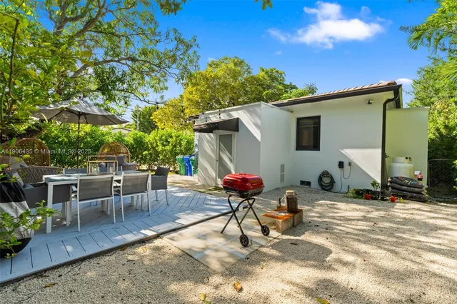an aerial view of a house with a yard and potted plants