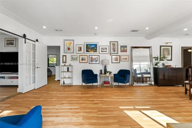 a living room with furniture and a wooden floor