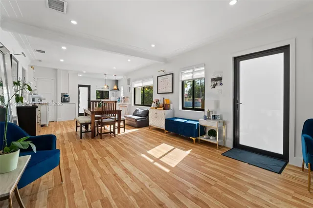 a view of a dining room with furniture and wooden floor