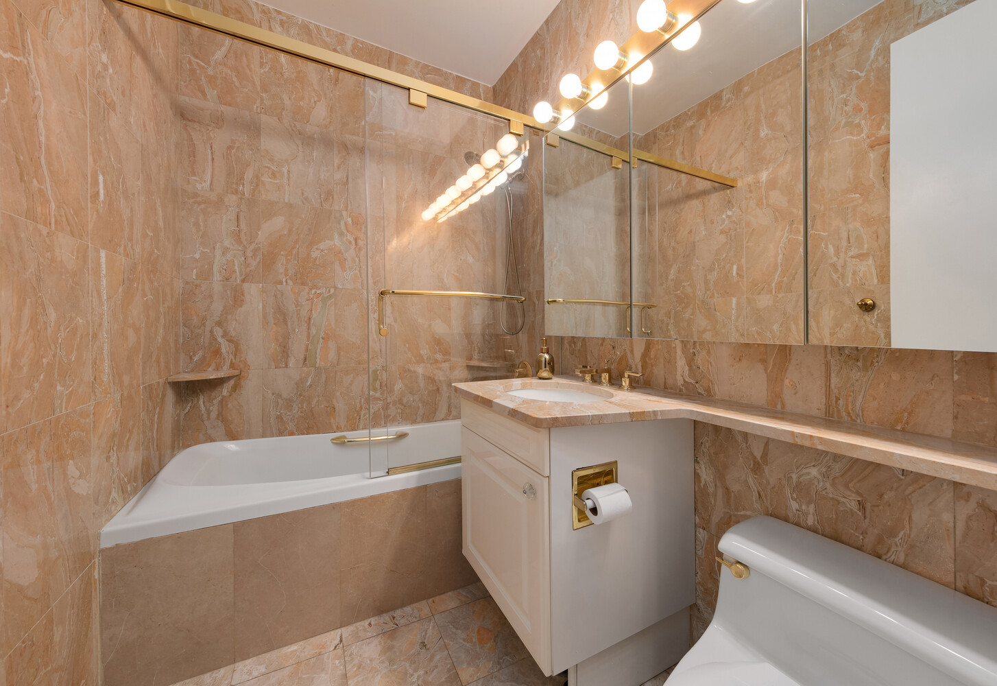 101 West 67th Street, Unit 52E Manhattan, NY 10023 - Photo 10 of 21 a bathroom with a sink a toilet and shower