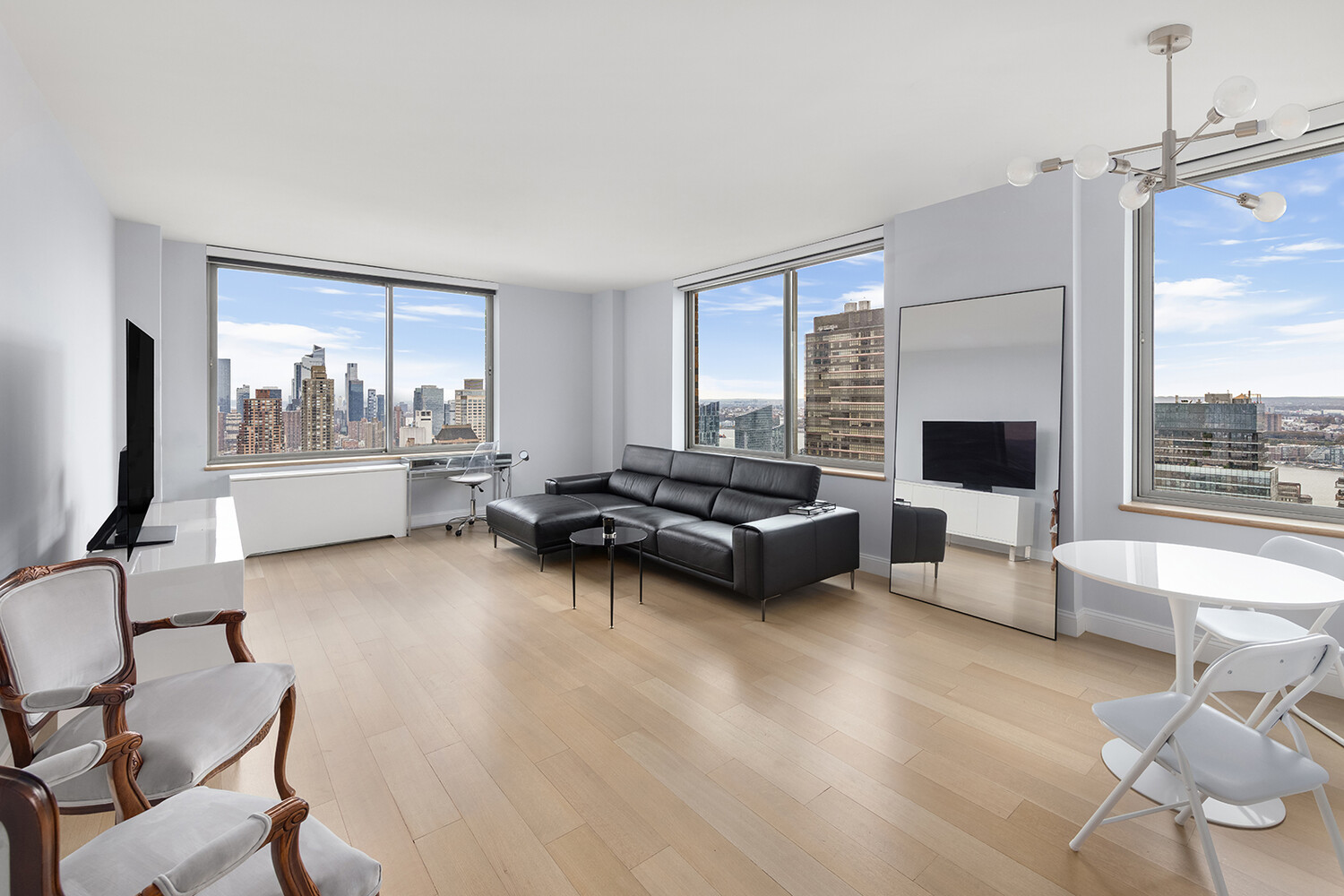 101 West 67th Street, Unit 52E Manhattan, NY 10023 - Photo 16 of 21 a living room with furniture and a large window