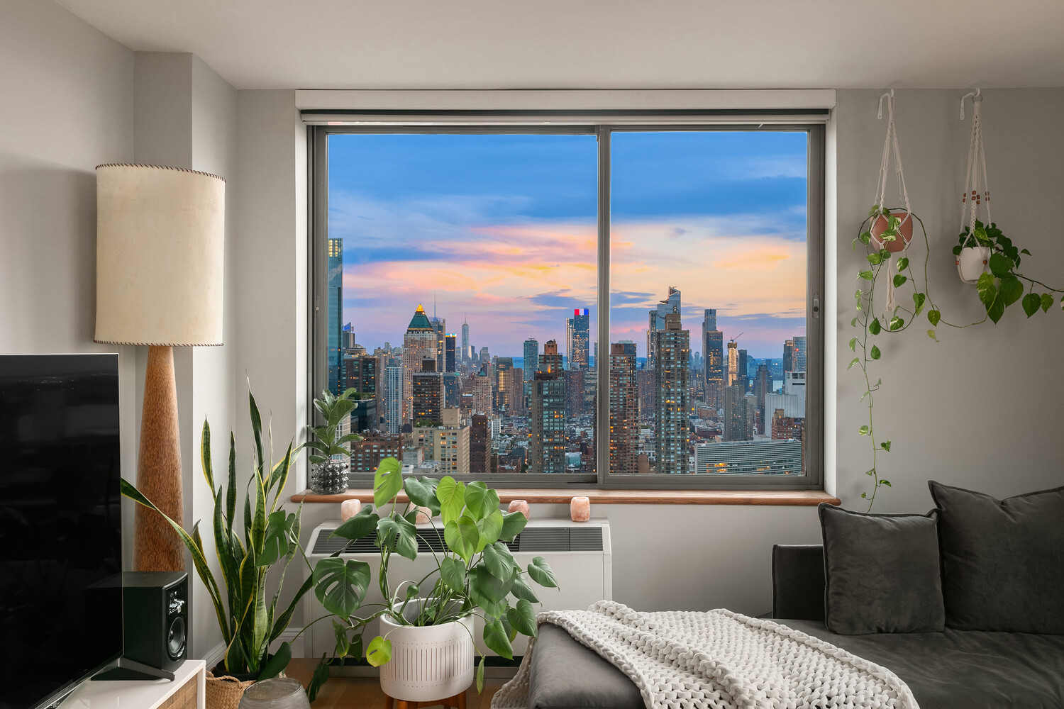 101 West 67th Street, Unit 52E Manhattan, NY 10023 - Photo 5 of 21 a view of a living room filled with furniture and a potted plant