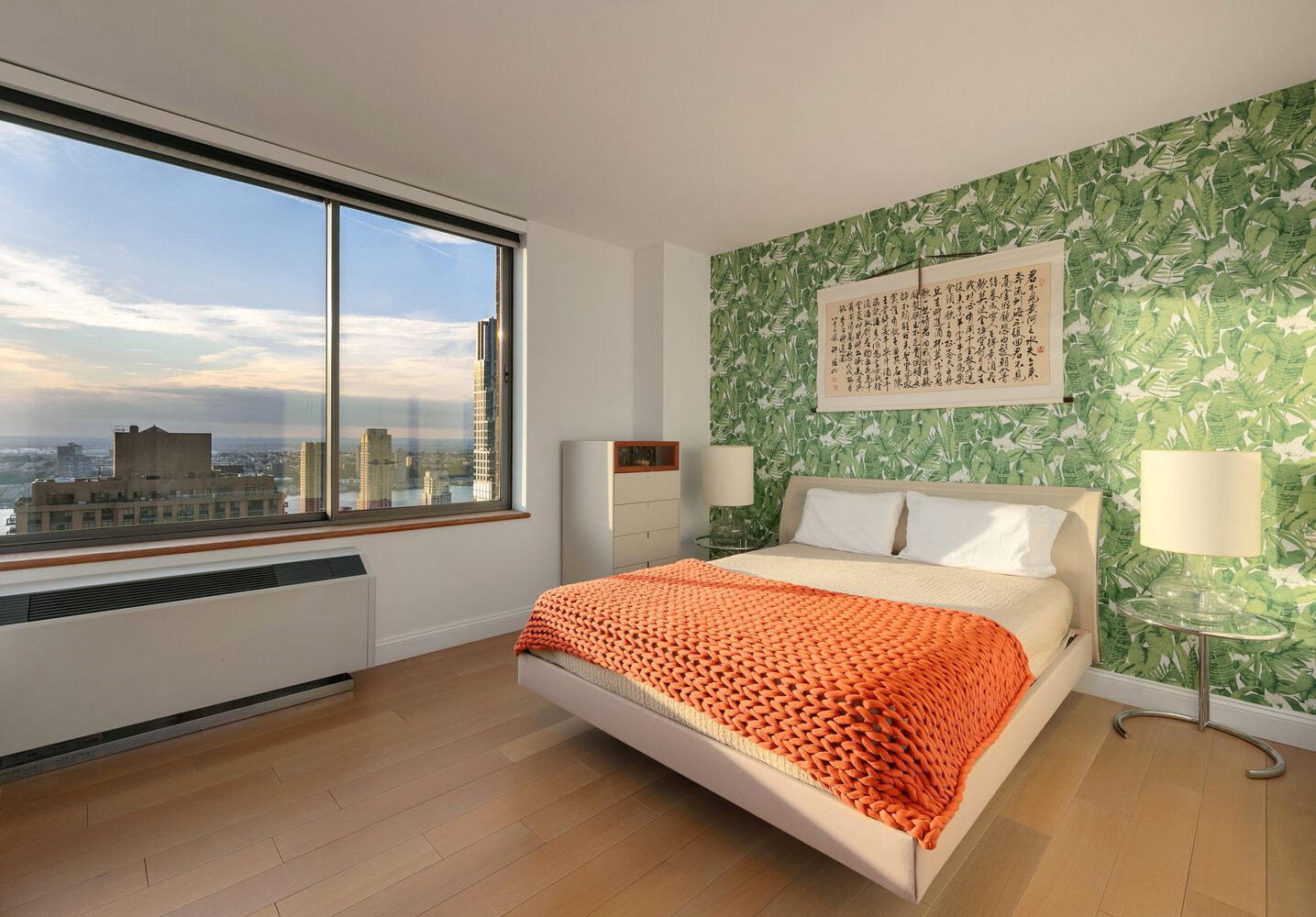 101 West 67th Street, Unit 52E Manhattan, NY 10023 - Photo 9 of 21 a large bed sitting in a bedroom next to a window