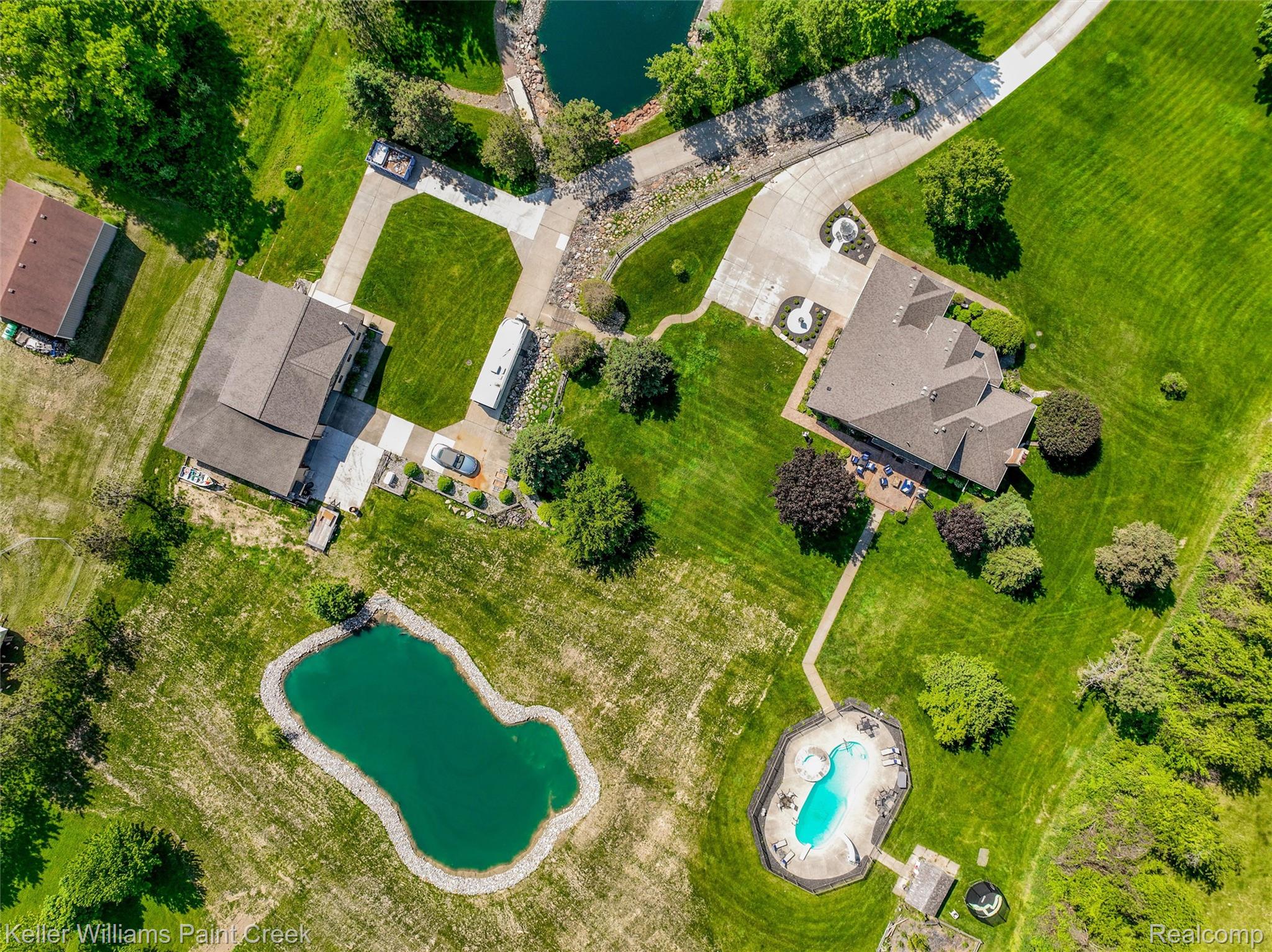 5813 36 Mile Road Romeo, MI 48065 - Photo 57 of 81 Expansive property featuring two distinct residences, a private swimming pool, and multiple ponds