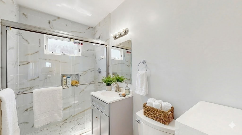 5 A Ropes Street, Unit 2 Salem, MA 01970 - Photo 4 of 9 a bathroom with a granite countertop sink mirror vanity and toilet
