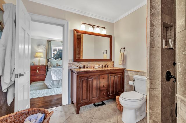 a bathroom with a toilet a sink and mirror