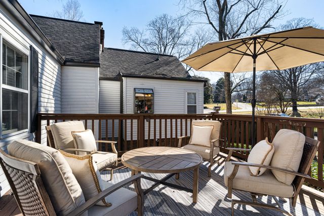 a view of a patio with a table and chairs under an umbrella