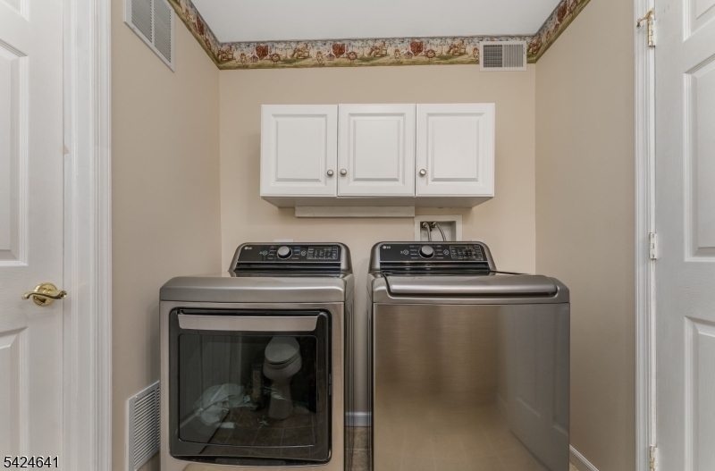 21 Marble Street Washington, NJ 07882 - Photo 15 of 21 a kitchen with a stove and white cabinets