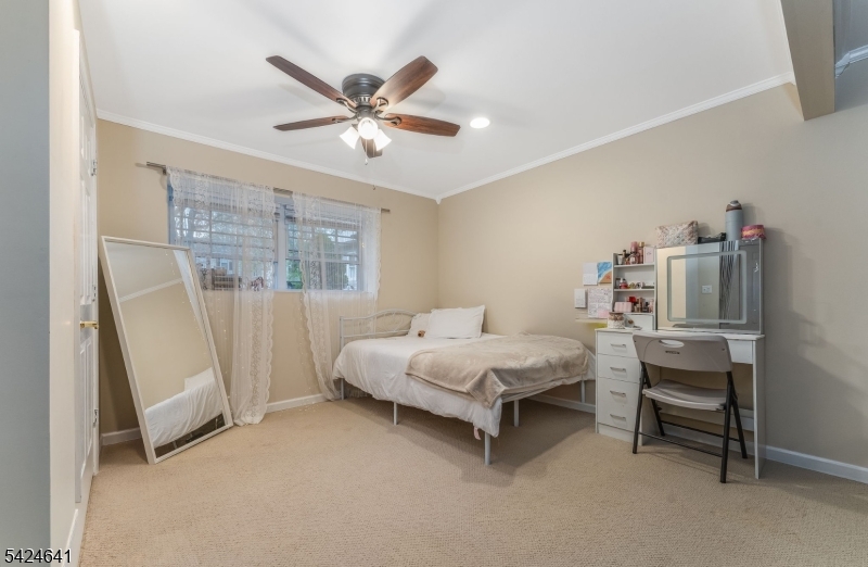 21 Marble Street Washington, NJ 07882 - Photo 10 of 21 a bedroom with a bed and a chandelier