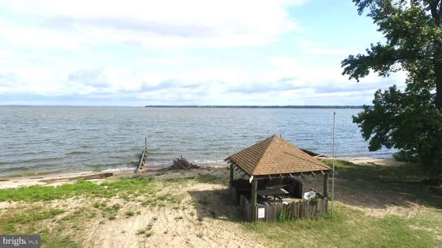 a aerial view of a house with a yard and lake view