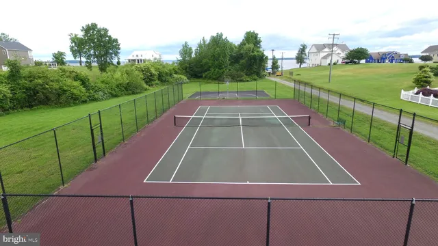 a view of a tennis court with a small yard