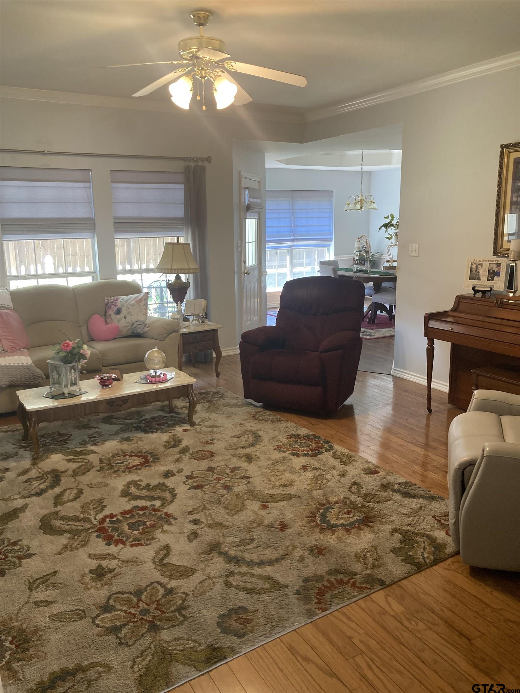 1521 Rice Road, Unit Q103 Tyler, TX 75703 - Photo 14 of 40 a living room with furniture and a chandelier
