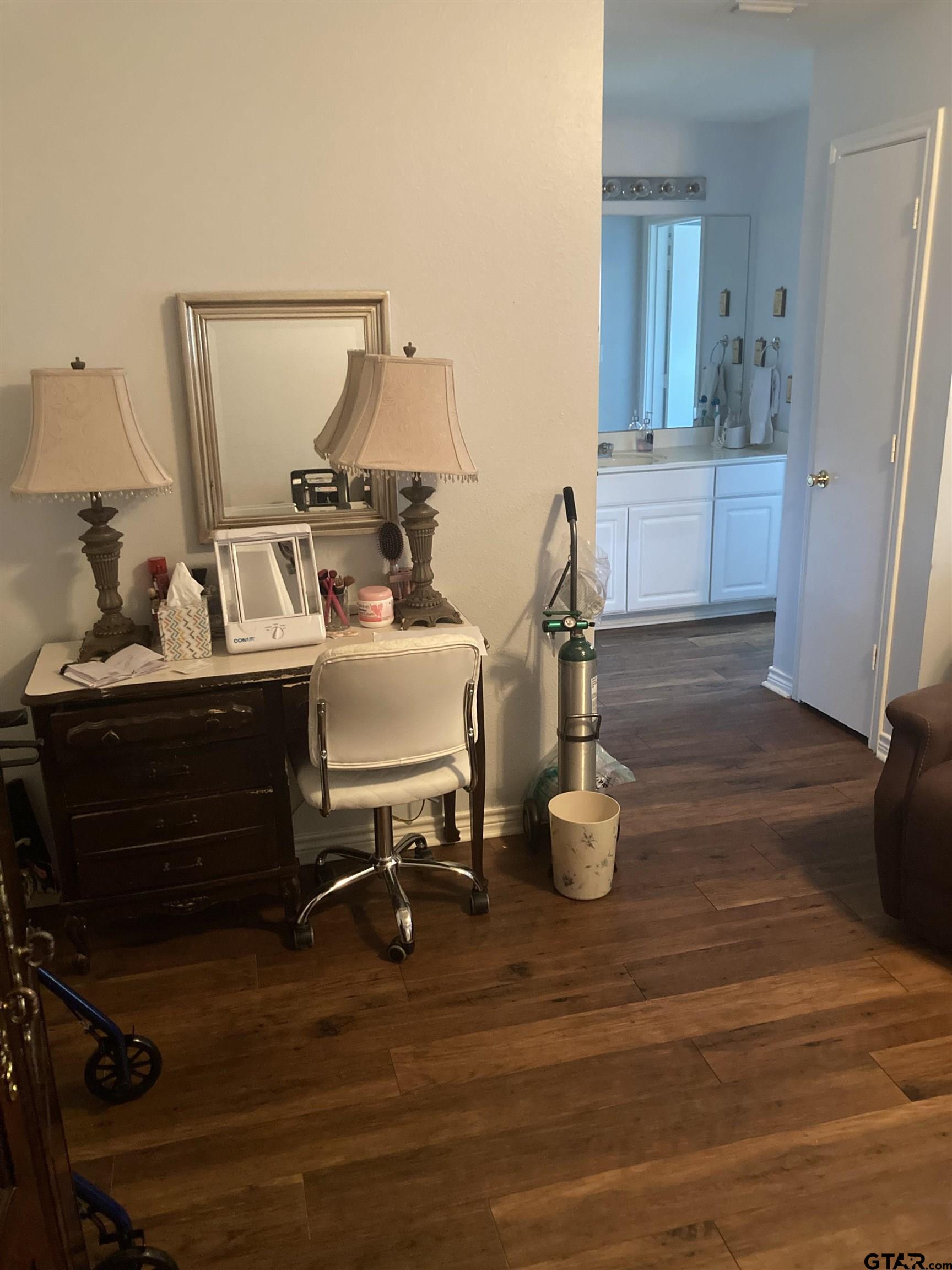 1521 Rice Road, Unit Q103 Tyler, TX 75703 - Photo 20 of 40 a room with wooden floor and furniture