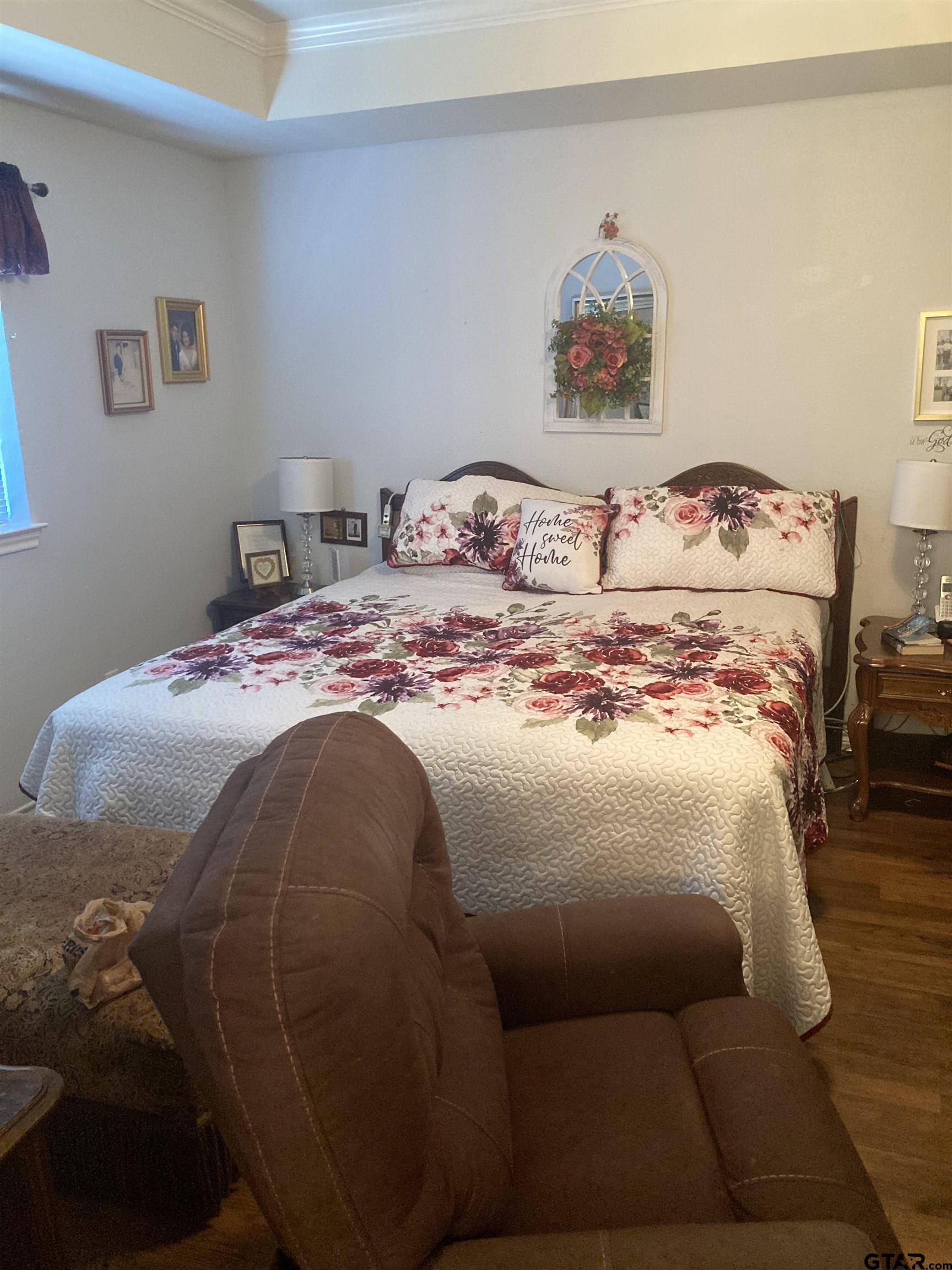 1521 Rice Road, Unit Q103 Tyler, TX 75703 - Photo 21 of 40 a bedroom with a bed and a couch