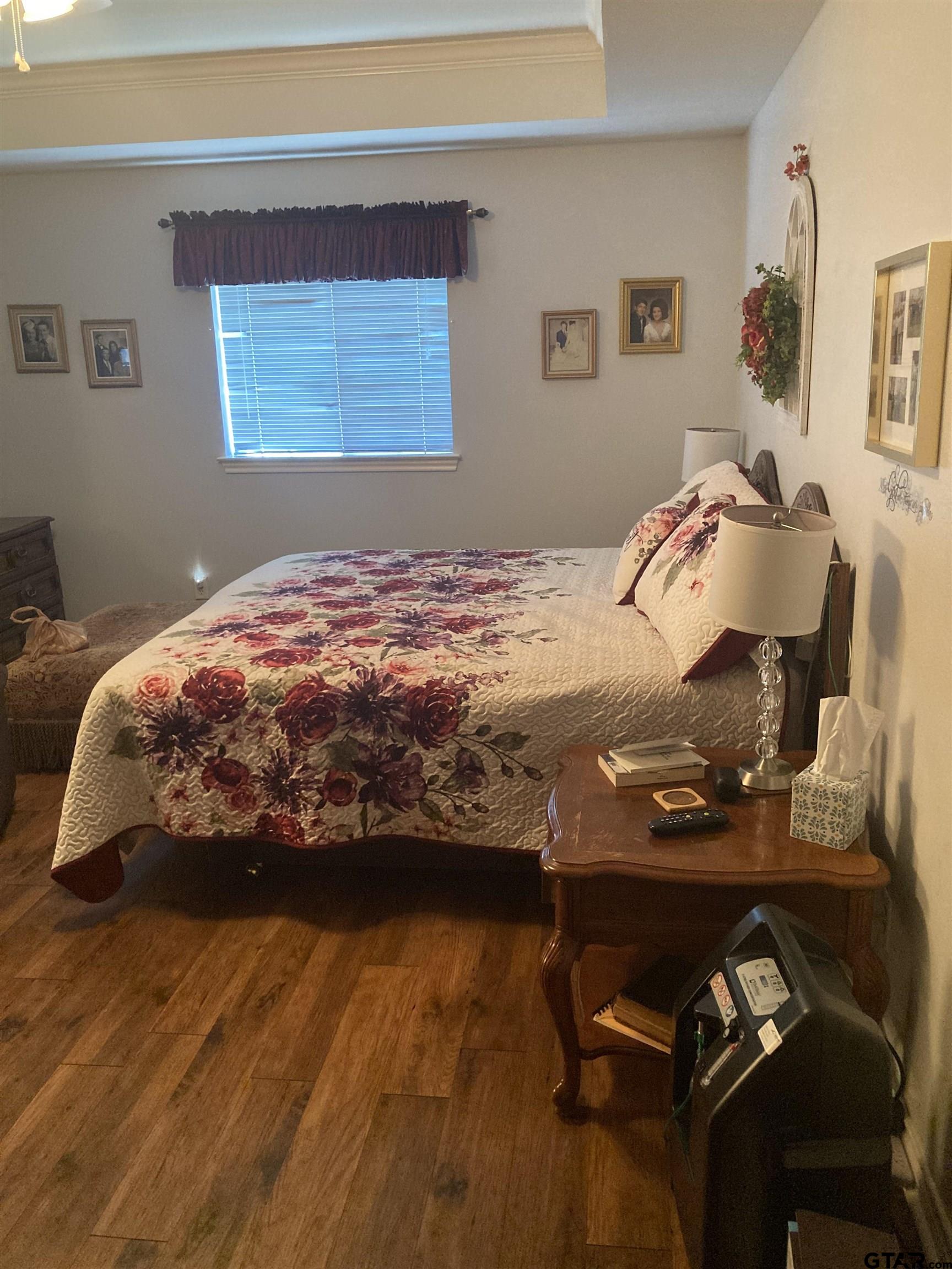 1521 Rice Road, Unit Q103 Tyler, TX 75703 - Photo 22 of 40 a bedroom with a bed and ceiling fan