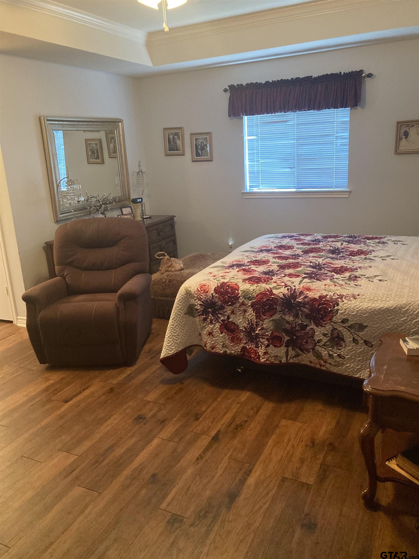 1521 Rice Road, Unit Q103 Tyler, TX 75703 - Photo 23 of 40 a bedroom with a bed and a couch