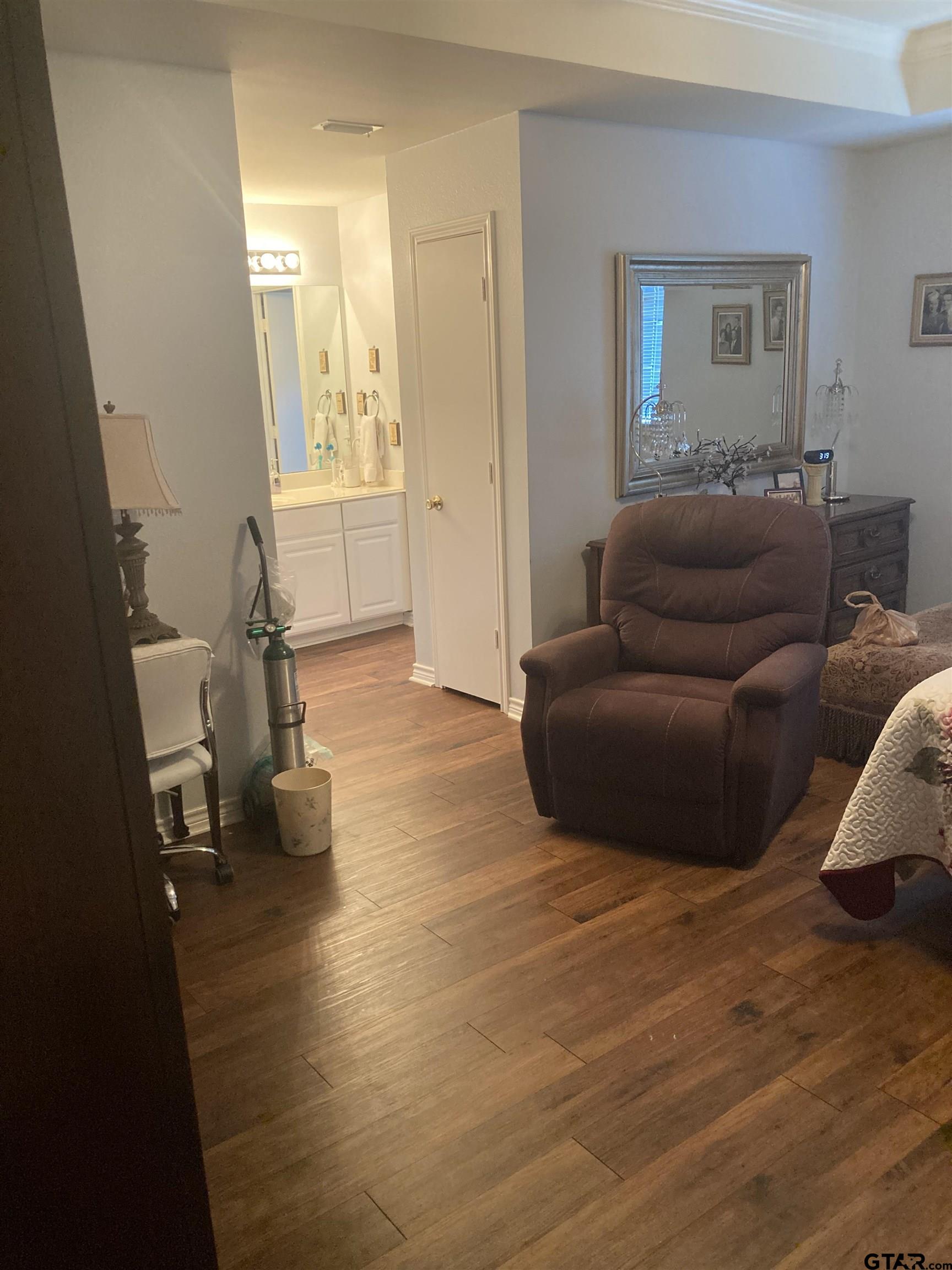 1521 Rice Road, Unit Q103 Tyler, TX 75703 - Photo 24 of 40 a living room with furniture and a wooden floor