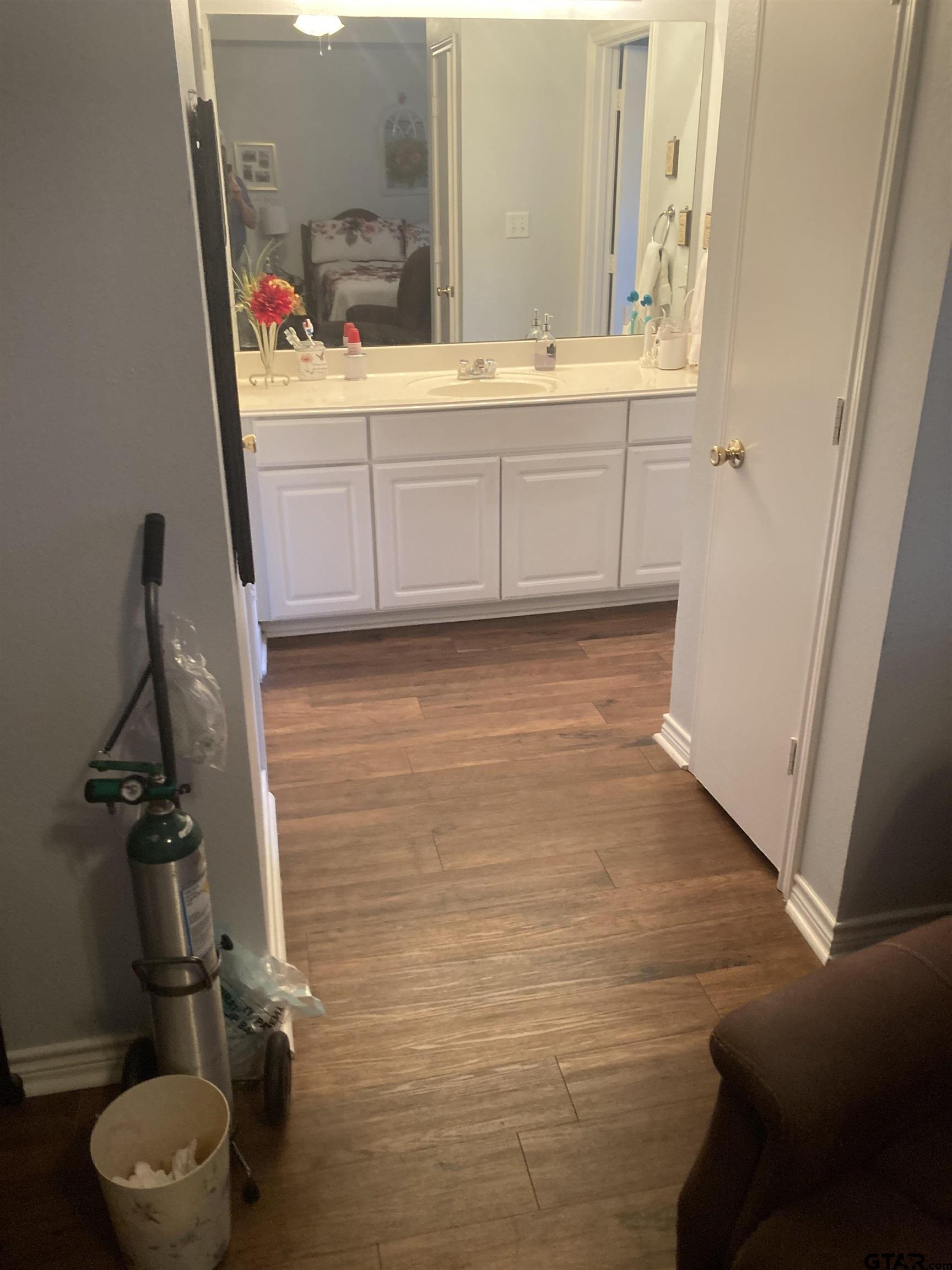1521 Rice Road, Unit Q103 Tyler, TX 75703 - Photo 25 of 40 a bathroom with a sink and a mirror