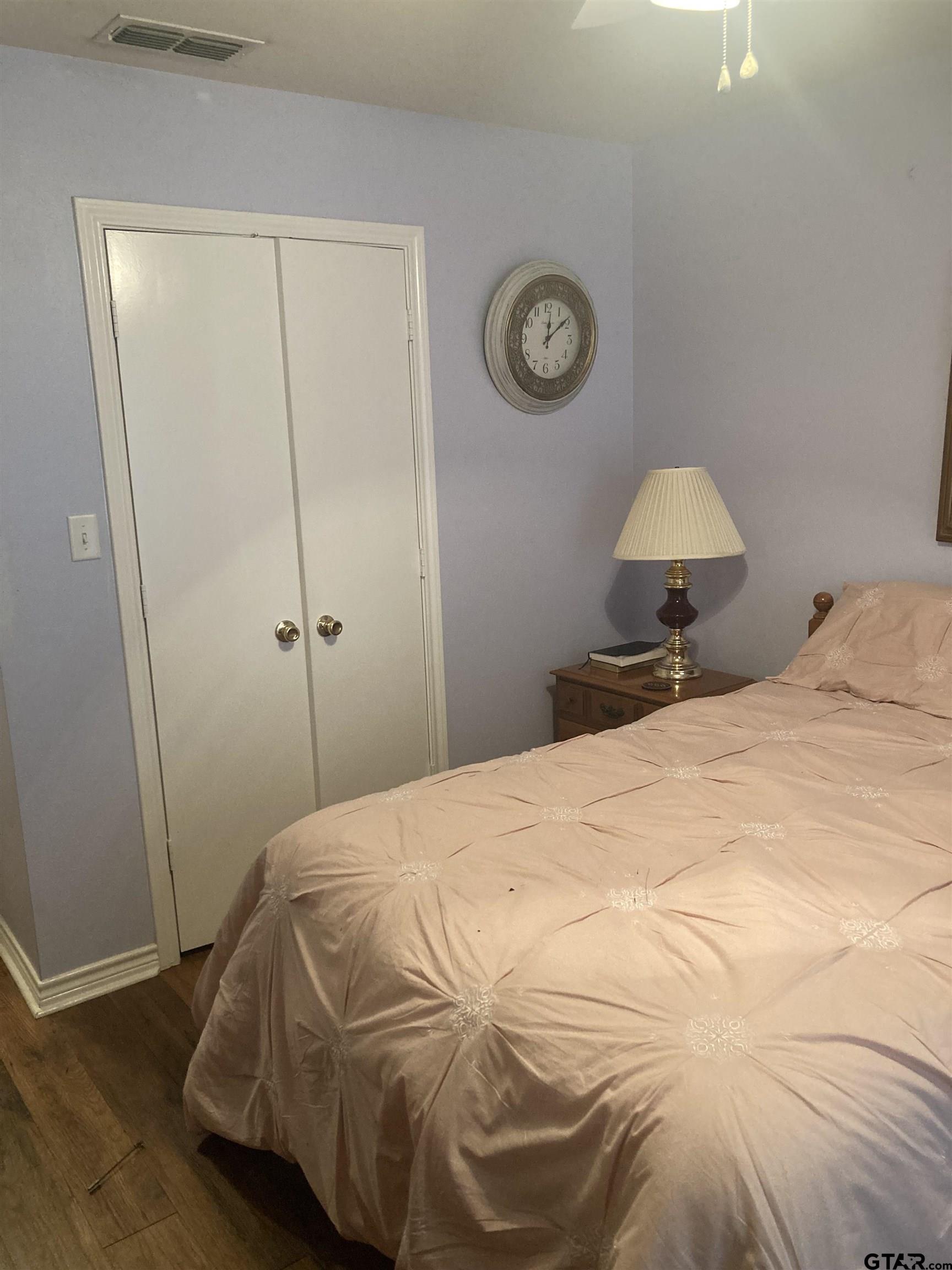 1521 Rice Road, Unit Q103 Tyler, TX 75703 - Photo 35 of 40 a bedroom with a bed and a closet