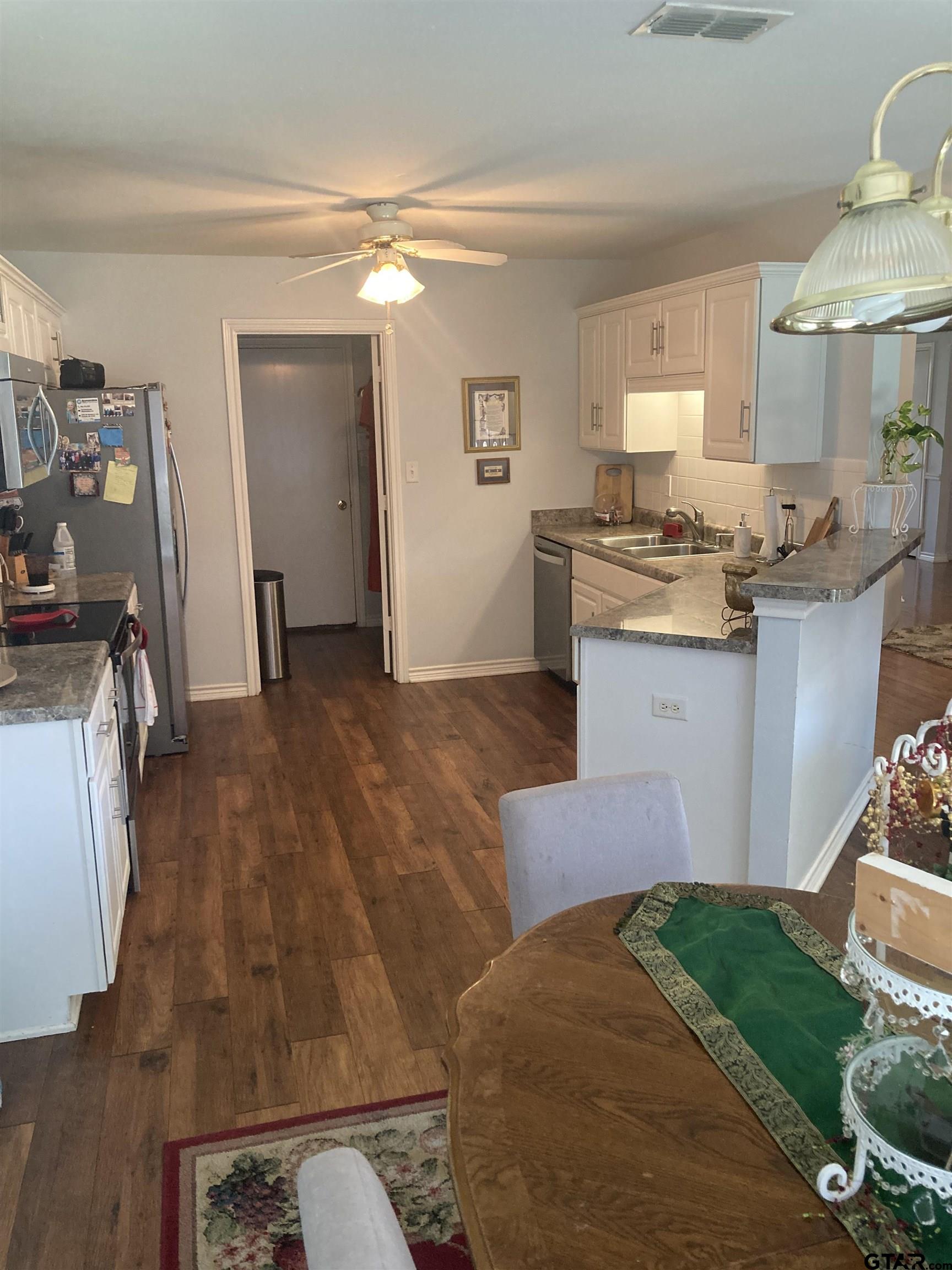 1521 Rice Road, Unit Q103 Tyler, TX 75703 - Photo 5 of 40 a kitchen with granite countertop a sink stove and cabinets