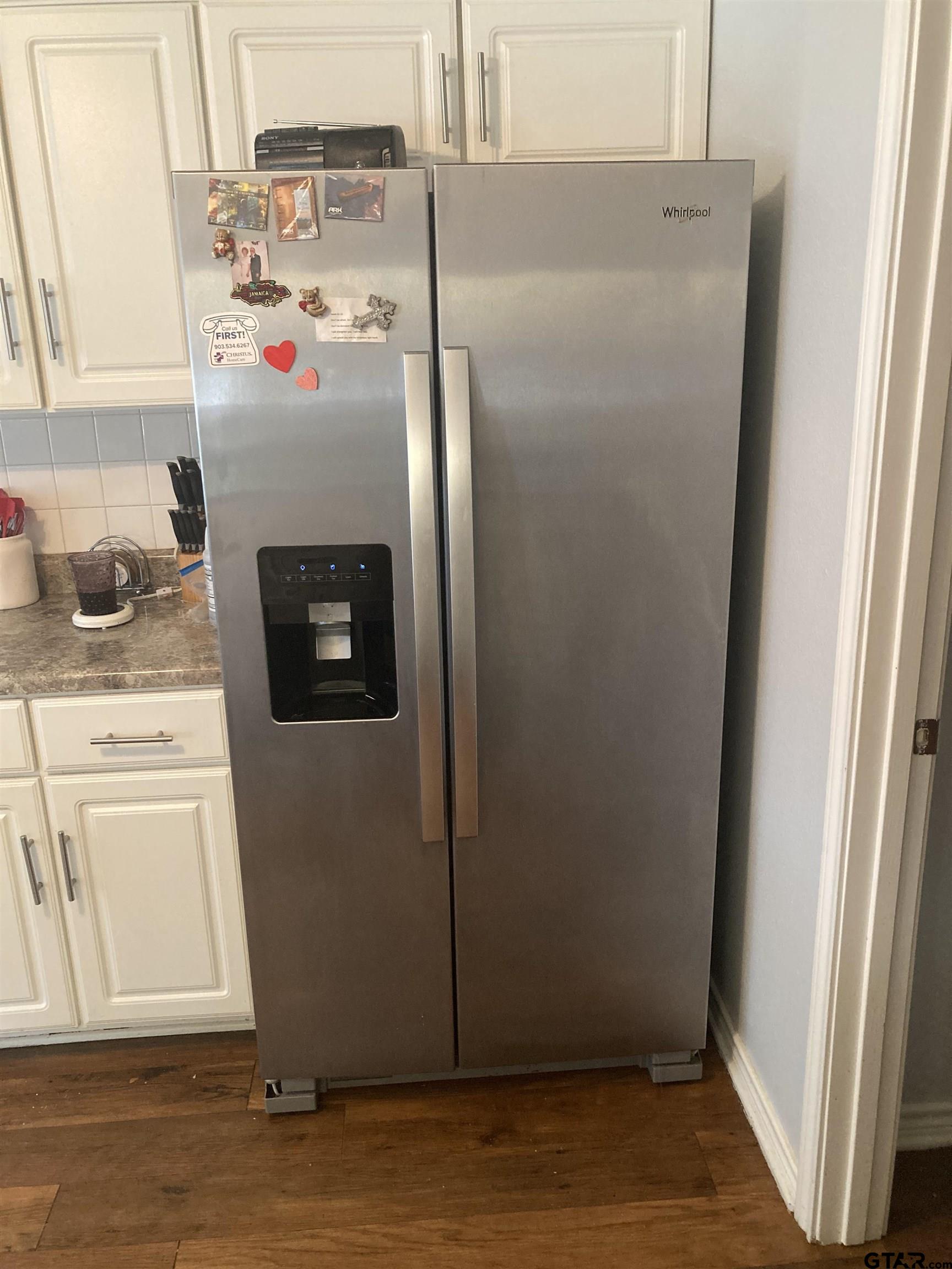 1521 Rice Road, Unit Q103 Tyler, TX 75703 - Photo 10 of 40 a white refrigerator freezer sitting inside of a kitchen