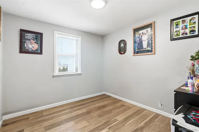 a view of a room with wooden floor and closet