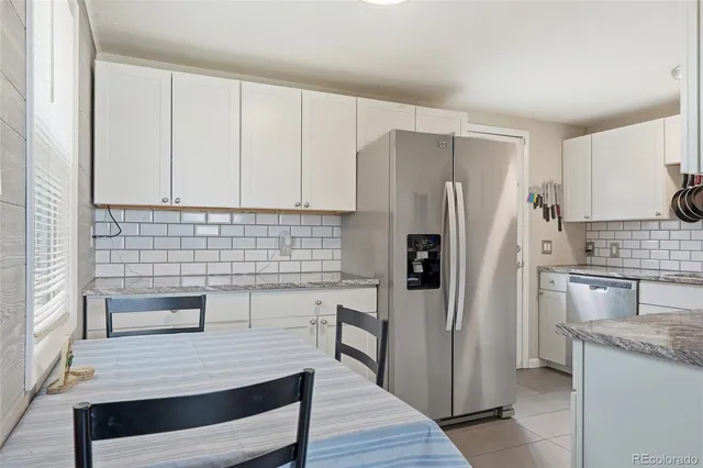 a kitchen with a refrigerator and a sink
