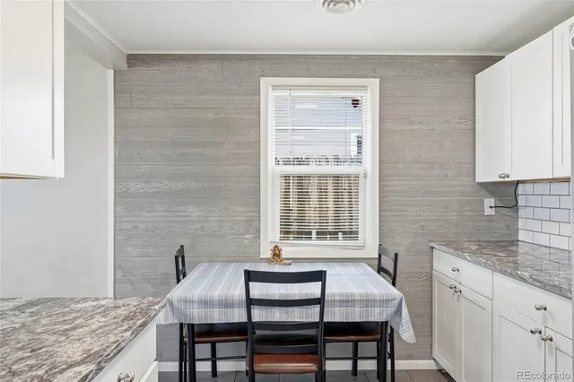 a dining room with furniture and window