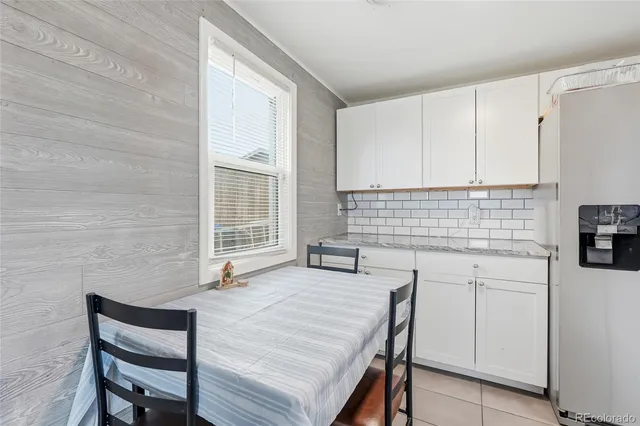 a kitchen with a sink a stove a table and chair