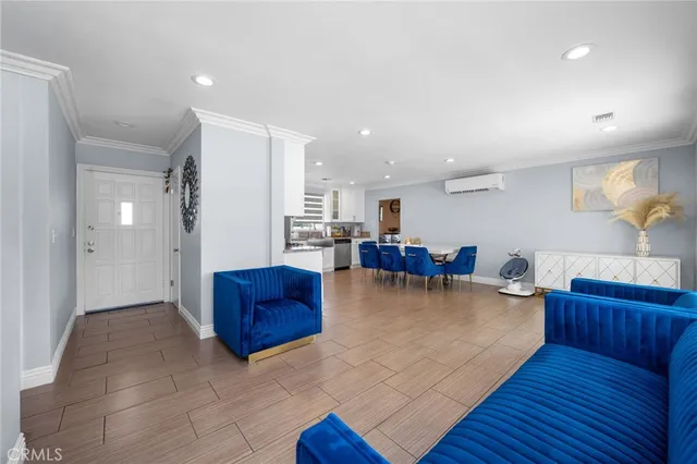 a living room with furniture and kitchen view