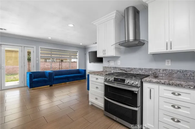 a kitchen with stainless steel appliances stove top oven and cabinets