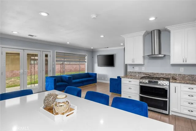 a kitchen with stainless steel appliances granite countertop a sink and a stove