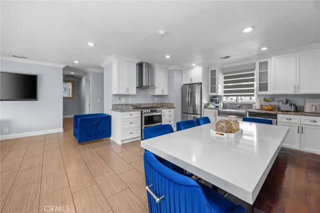 a kitchen with stainless steel appliances granite countertop a sink a stove top oven a counter space and cabinets