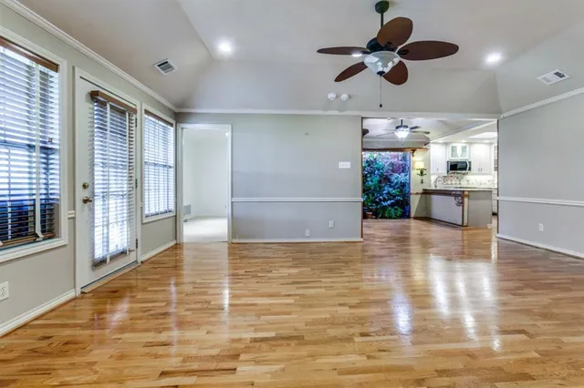 a view of kitchen and window with wooden floor