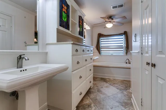 a bathroom with a sink a vanity and a mirror