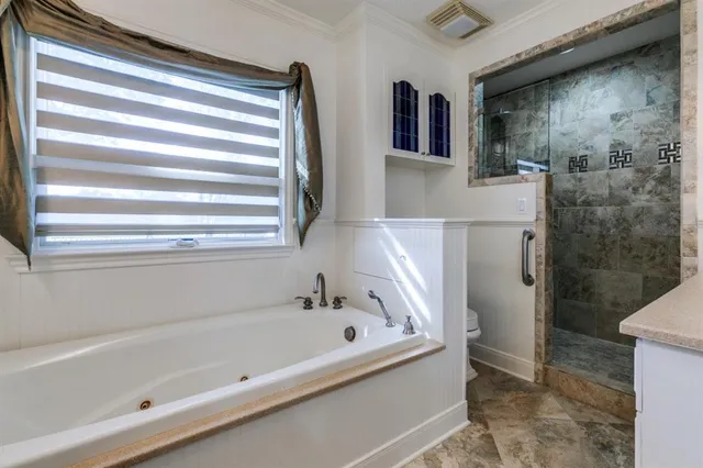 a bathroom with a bathtub and a shower