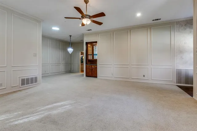 an empty room with closet and windows