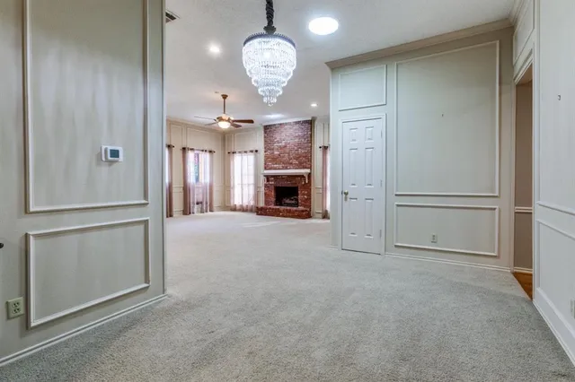 an empty room with fan and entrance