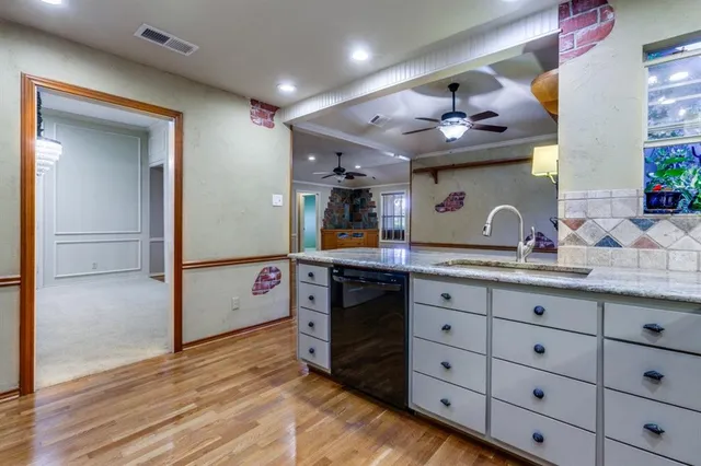 a kitchen with a sink stove and cabinets