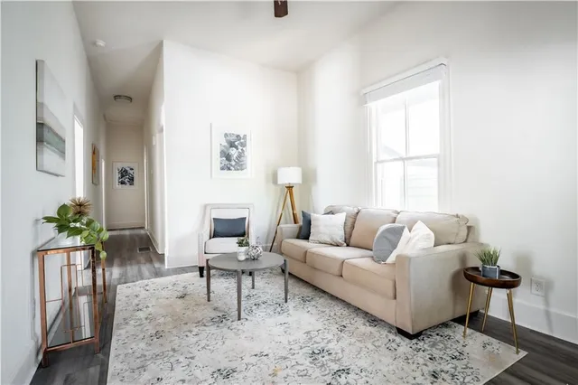 a living room with furniture and wooden floor