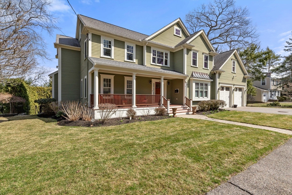 a view of a house with a large tree and plants