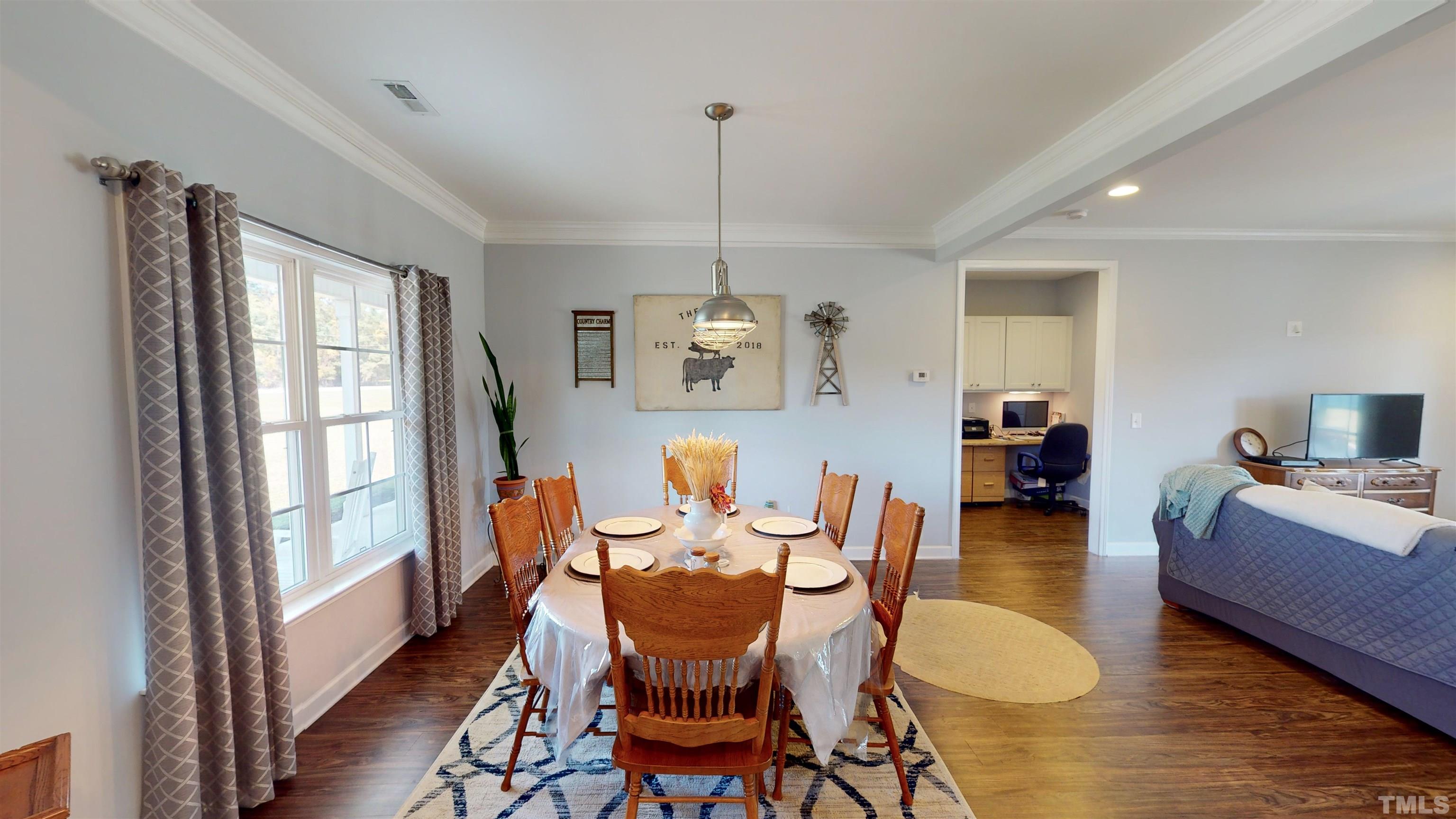 11250 Old Beulah Road Kenly, NC 27542 - Photo 12 of 66 a dining room with furniture a chandelier and wooden floor