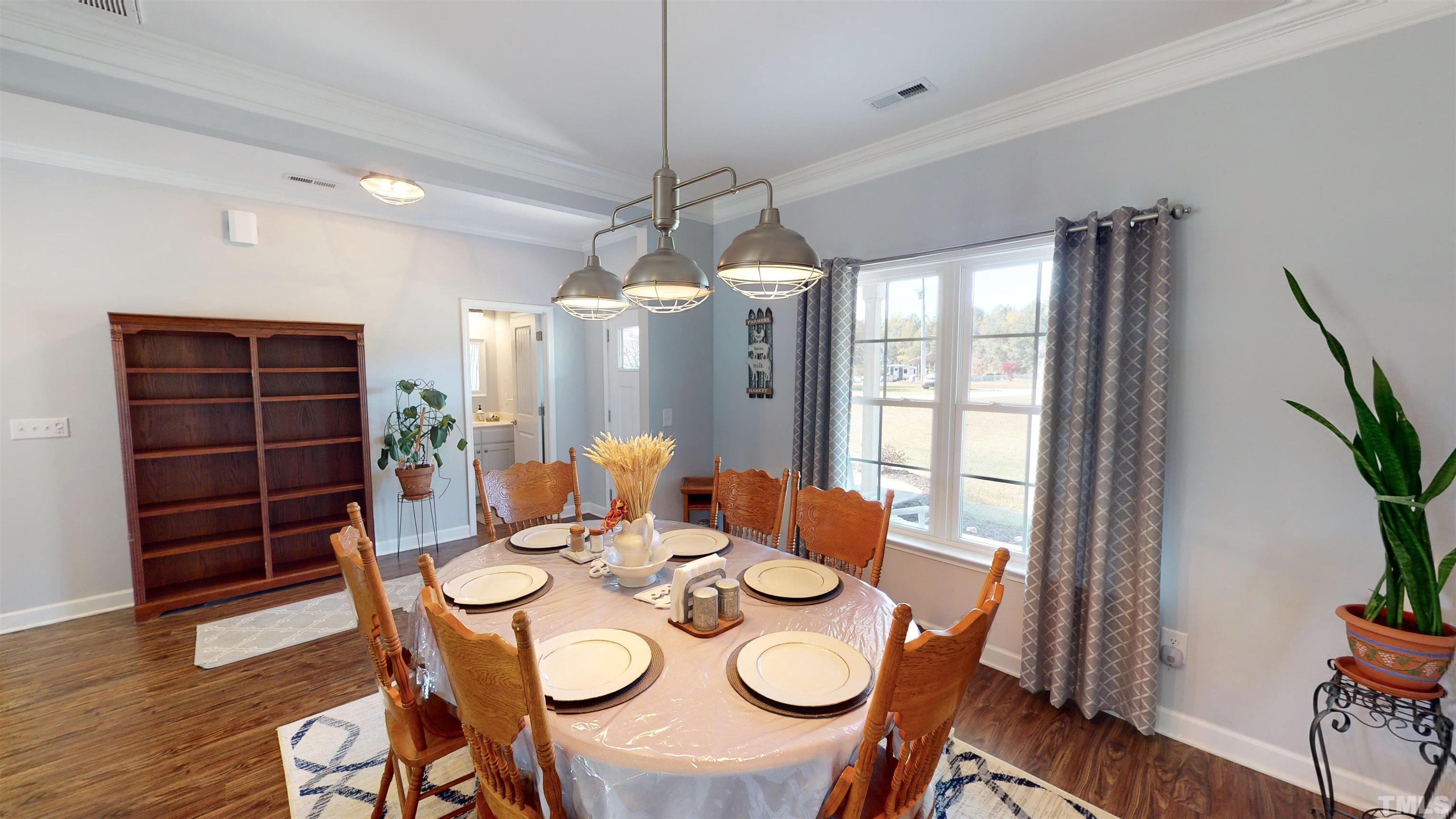 11250 Old Beulah Road Kenly, NC 27542 - Photo 15 of 66 a view of a dining room with furniture window and wooden floor
