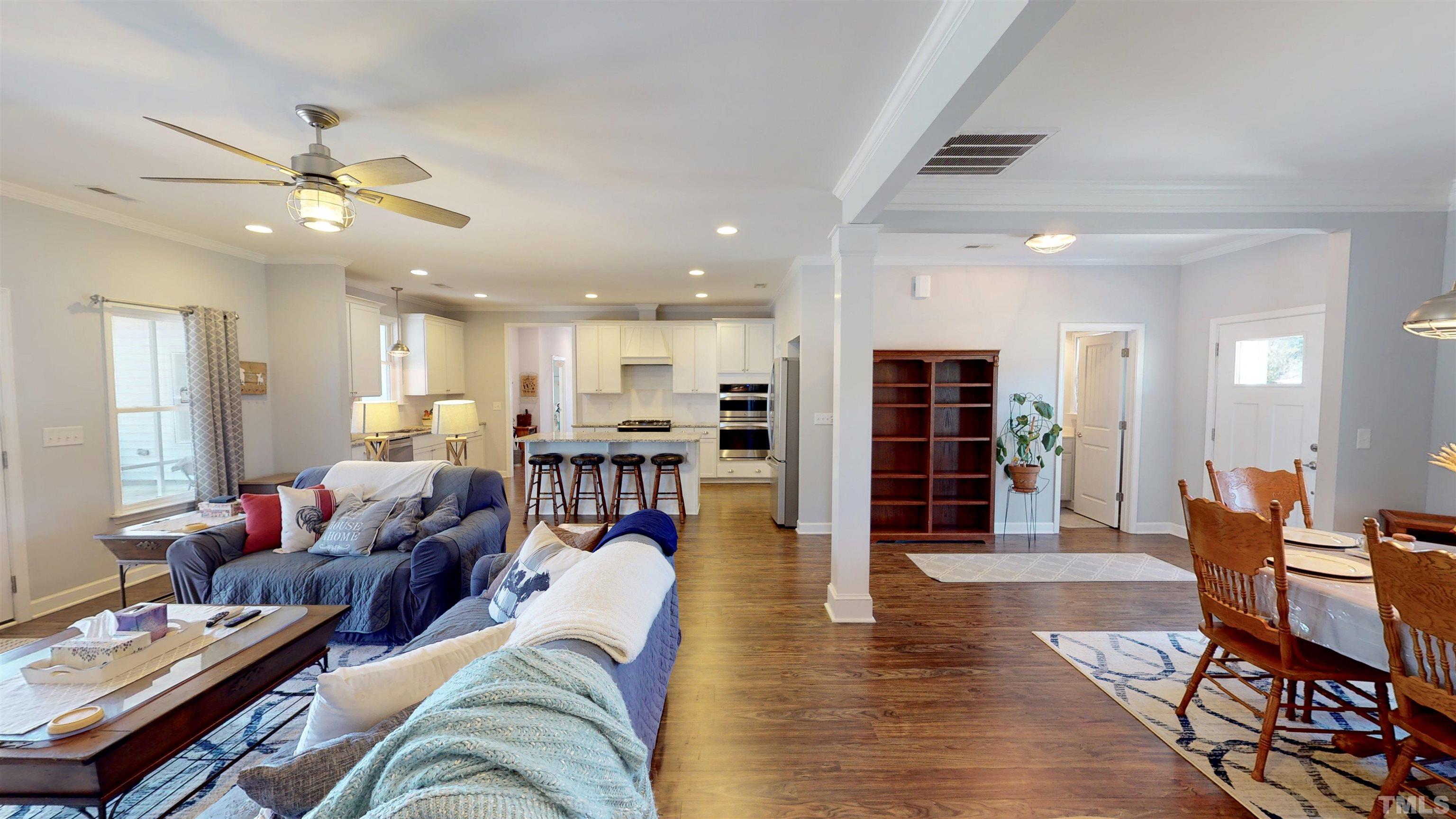 11250 Old Beulah Road Kenly, NC 27542 - Photo 17 of 66 a living room with furniture kitchen view and a wooden floor