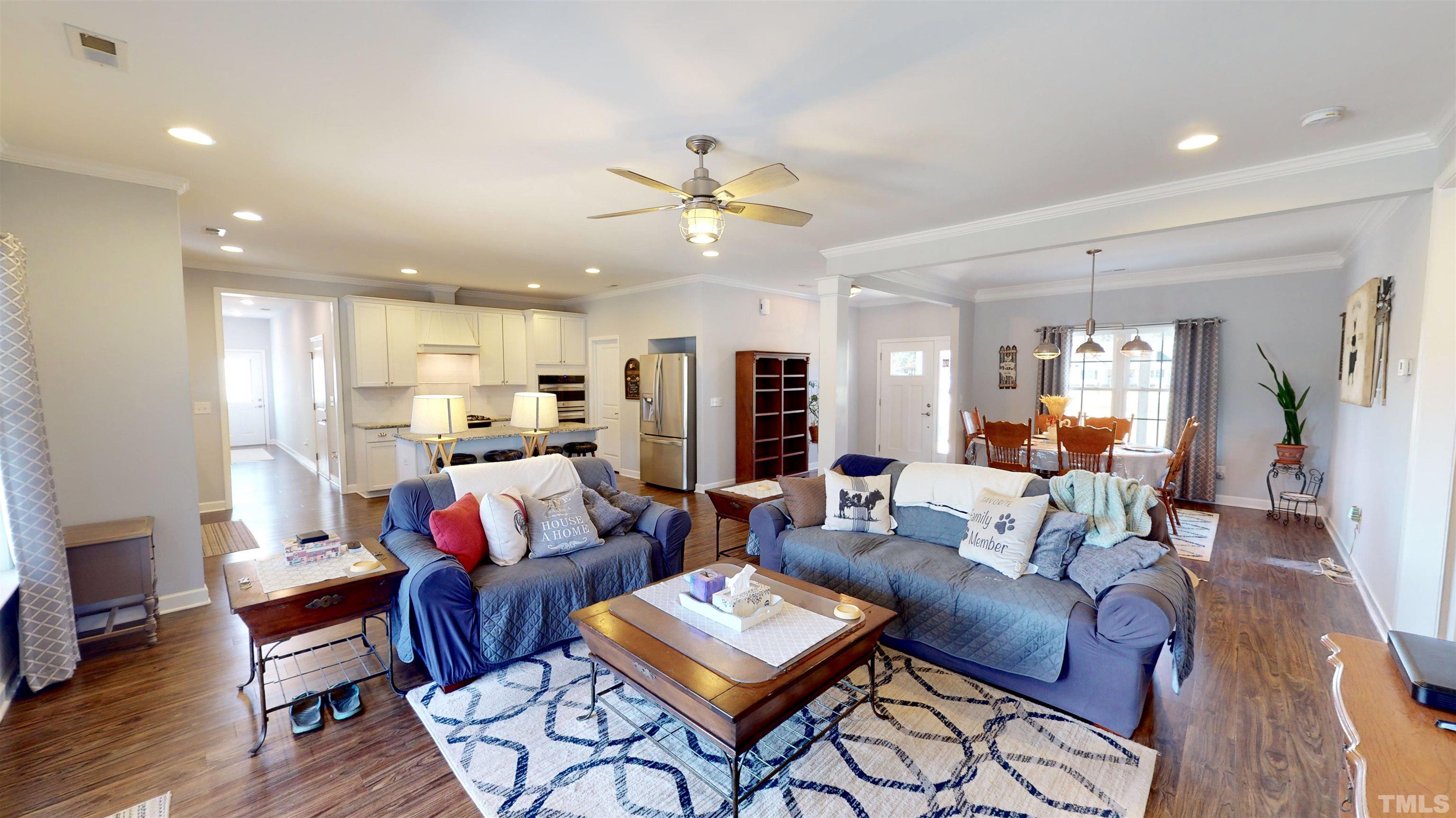 11250 Old Beulah Road Kenly, NC 27542 - Photo 19 of 66 a living room with furniture kitchen view and a chandelier