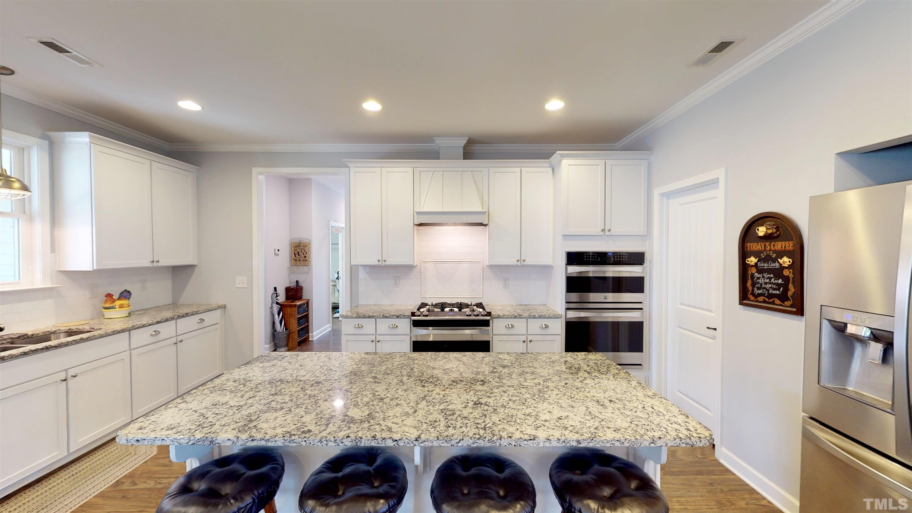 11250 Old Beulah Road Kenly, NC 27542 - Photo 22 of 66 a kitchen with a refrigerator and a stove top oven