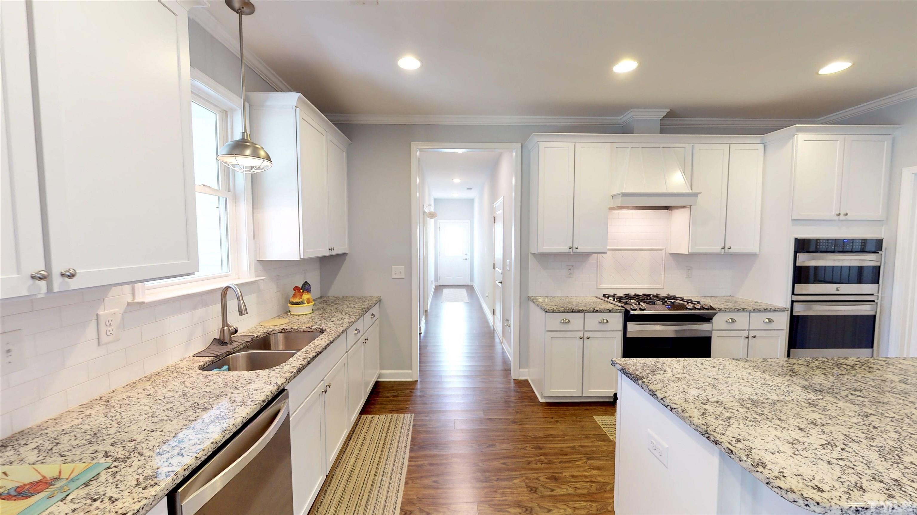 11250 Old Beulah Road Kenly, NC 27542 - Photo 24 of 66 a kitchen with a stove sink and refrigerator