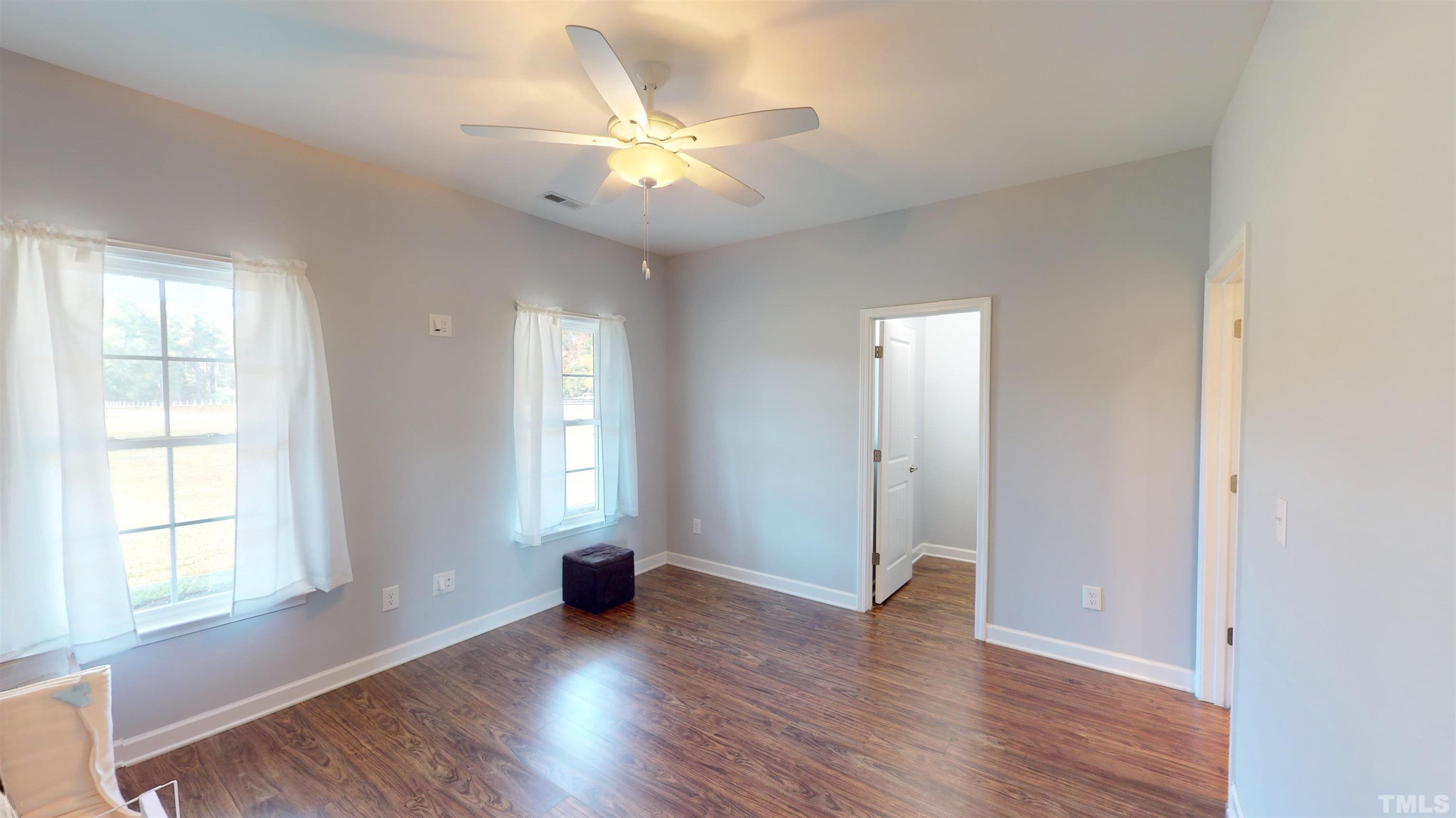 11250 Old Beulah Road Kenly, NC 27542 - Photo 35 of 66 an empty room with wooden floor and windows
