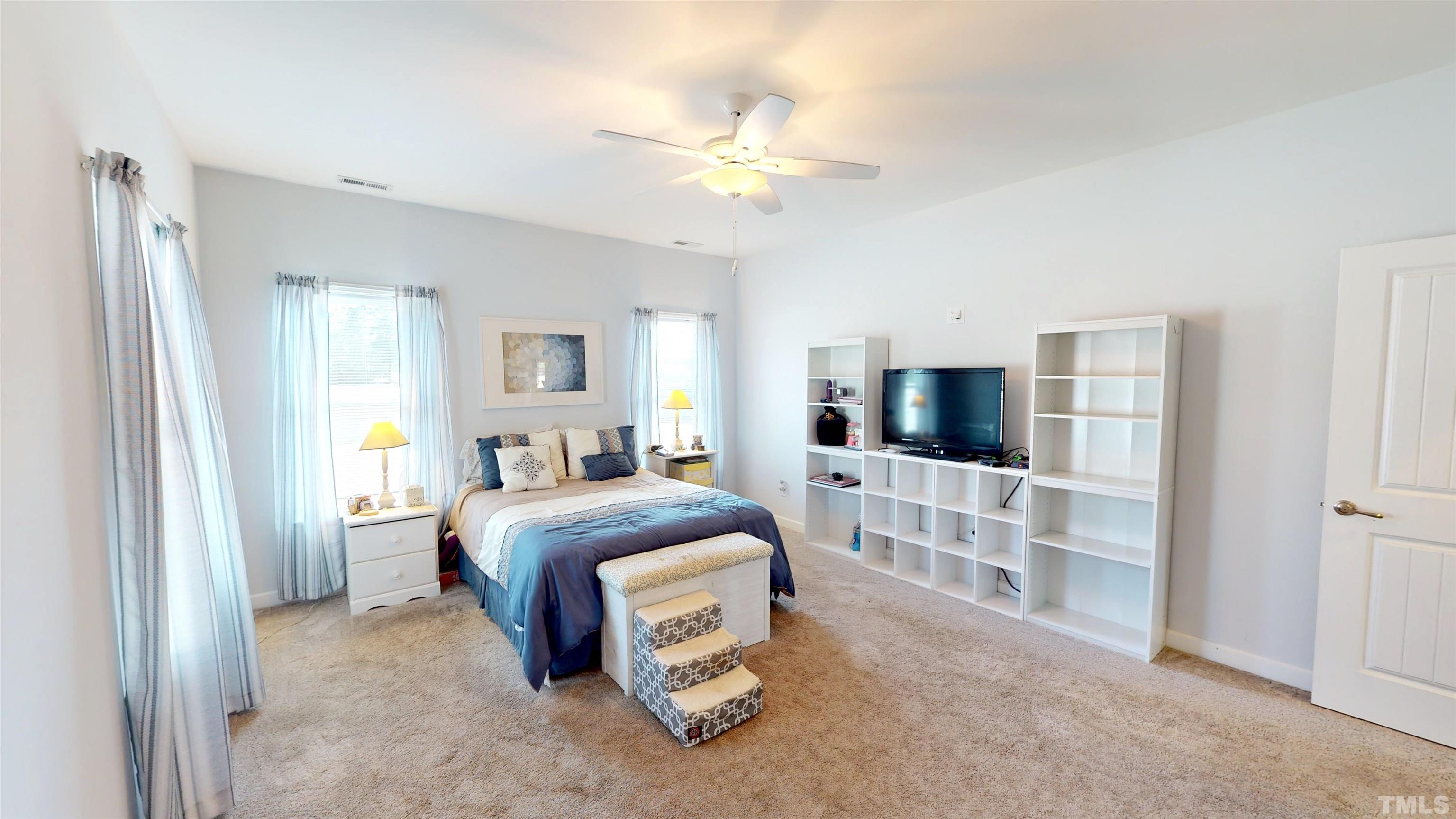 11250 Old Beulah Road Kenly, NC 27542 - Photo 38 of 66 a spacious bedroom with a bed and a flat screen tv