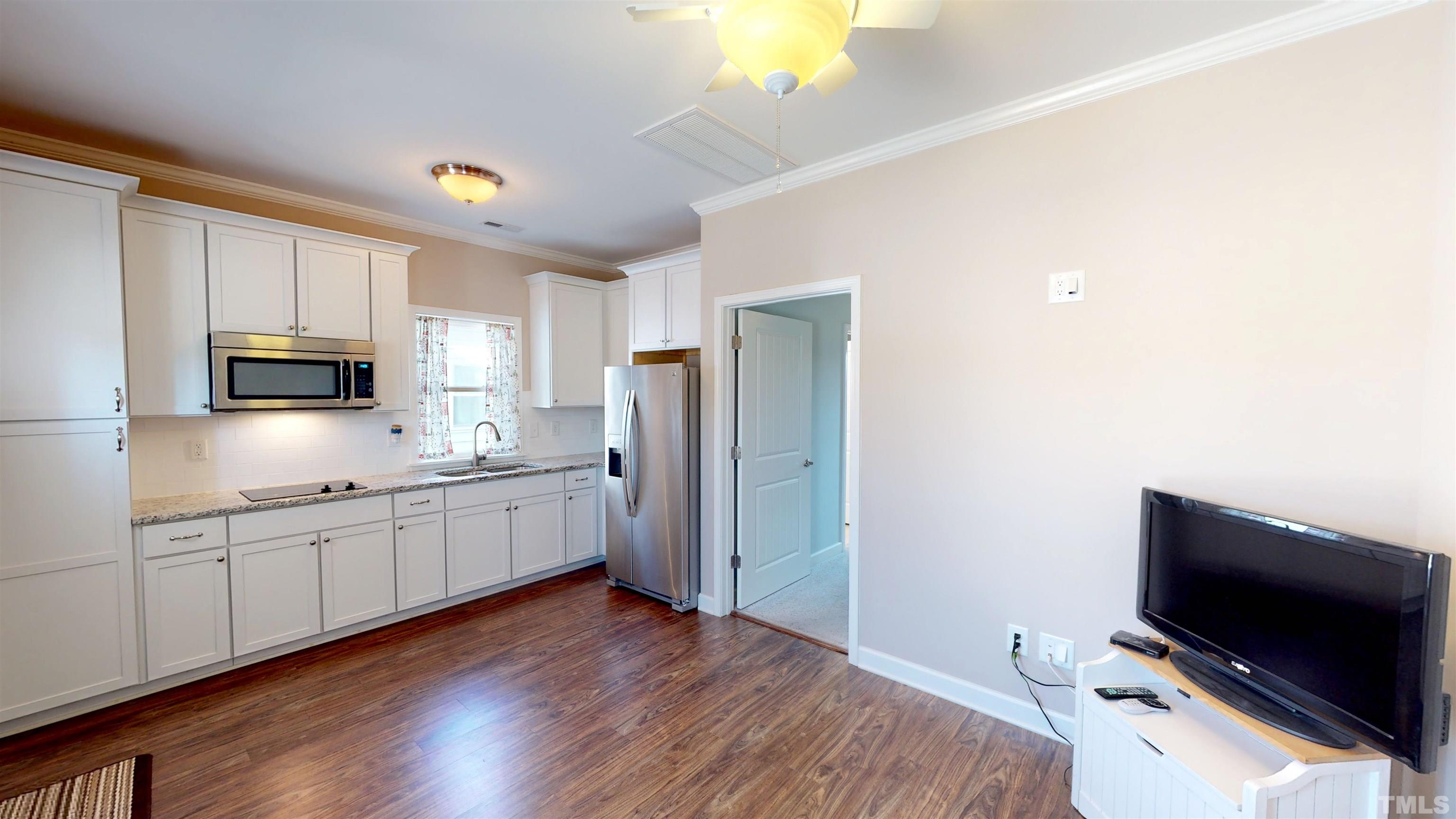 11250 Old Beulah Road Kenly, NC 27542 - Photo 49 of 66 a kitchen with appliances a sink and cabinets